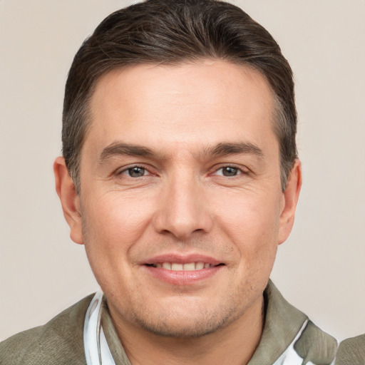 Joyful white adult male with short  brown hair and brown eyes