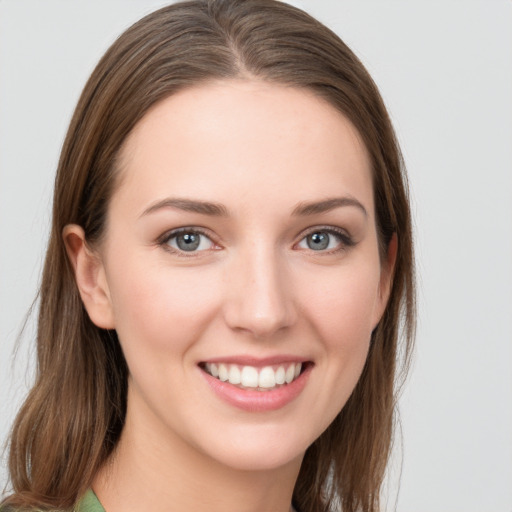 Joyful white young-adult female with long  brown hair and grey eyes