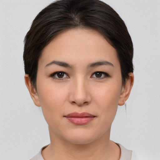 Joyful asian young-adult female with short  brown hair and brown eyes