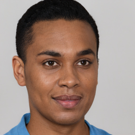 Joyful black young-adult male with short  brown hair and brown eyes