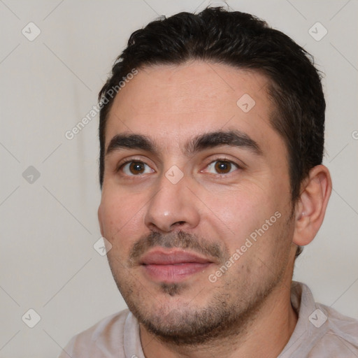 Joyful white young-adult male with short  black hair and brown eyes