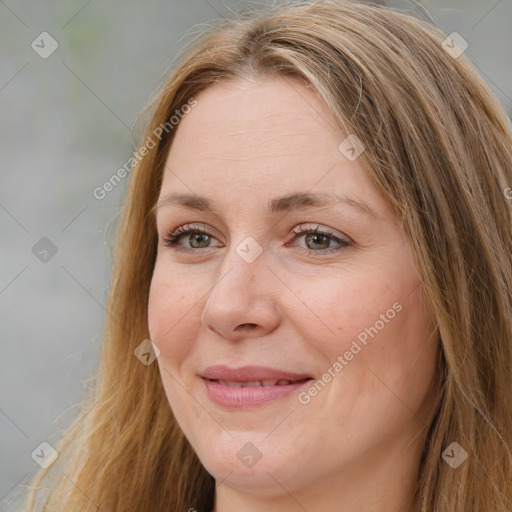 Joyful white adult female with long  brown hair and green eyes