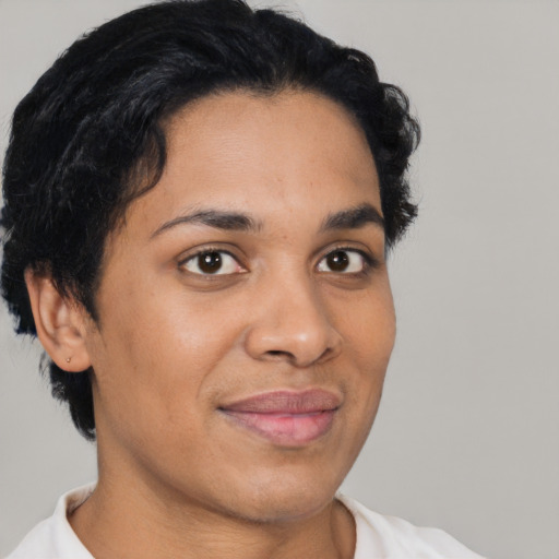 Joyful black young-adult female with short  black hair and brown eyes