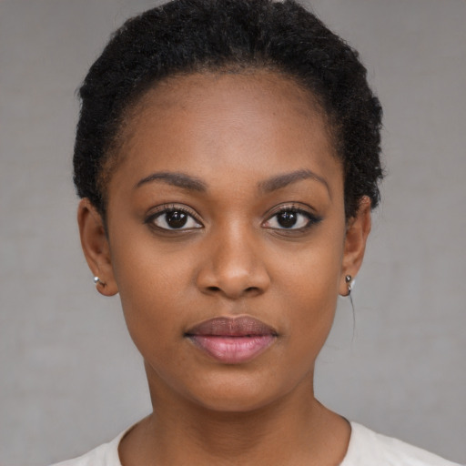 Joyful black young-adult female with short  brown hair and brown eyes