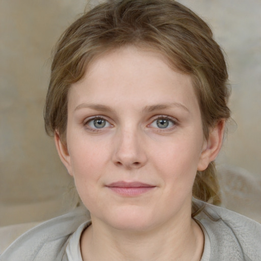 Joyful white young-adult female with medium  brown hair and blue eyes