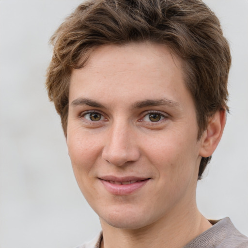 Joyful white young-adult female with short  brown hair and grey eyes