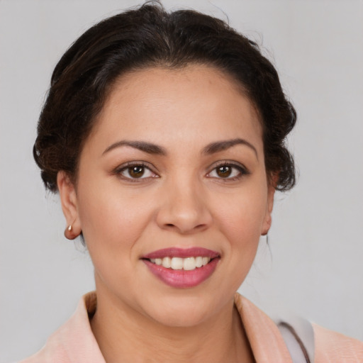 Joyful latino young-adult female with medium  brown hair and brown eyes