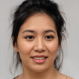 Joyful asian young-adult female with medium  brown hair and brown eyes