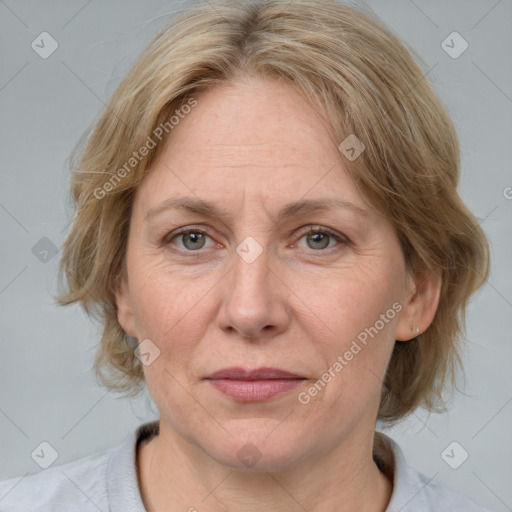 Joyful white adult female with medium  brown hair and blue eyes