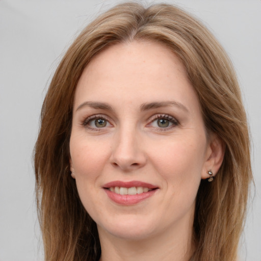 Joyful white young-adult female with long  brown hair and grey eyes