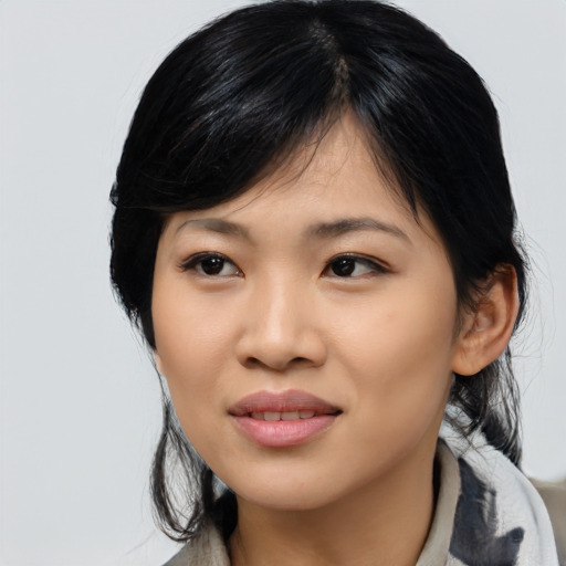 Joyful asian young-adult female with medium  black hair and brown eyes