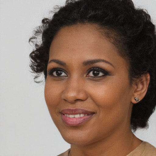 Joyful black young-adult female with medium  brown hair and brown eyes