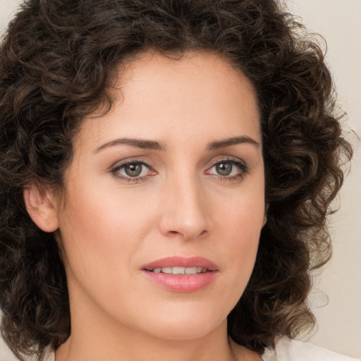 Joyful white young-adult female with medium  brown hair and green eyes