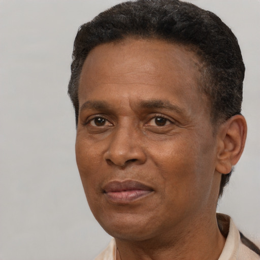Joyful black adult male with short  brown hair and brown eyes
