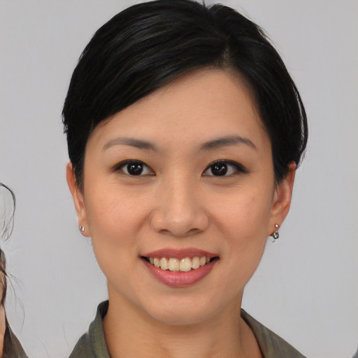 Joyful asian young-adult female with medium  black hair and brown eyes