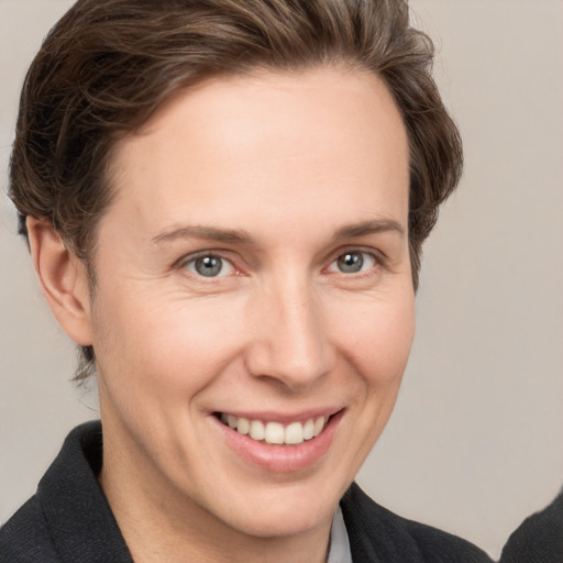 Joyful white adult female with short  brown hair and grey eyes