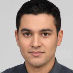 Joyful white young-adult male with short  black hair and brown eyes