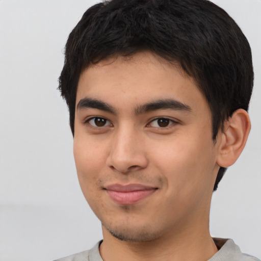 Joyful asian young-adult male with short  brown hair and brown eyes