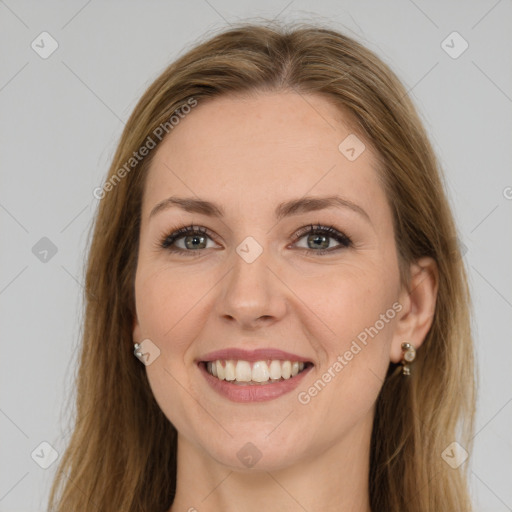 Joyful white young-adult female with long  brown hair and green eyes