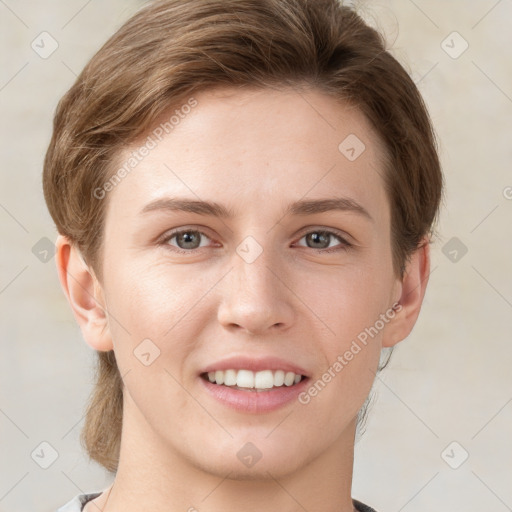 Joyful white young-adult female with short  brown hair and grey eyes