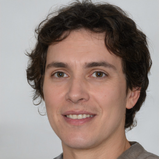 Joyful white young-adult male with medium  brown hair and brown eyes