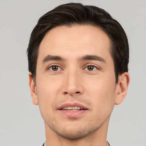 Joyful white young-adult male with short  brown hair and brown eyes