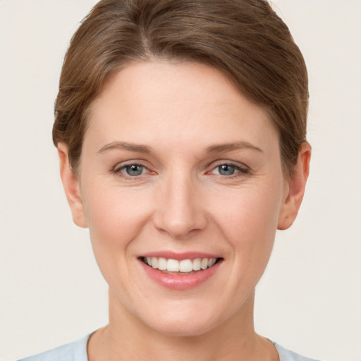 Joyful white young-adult female with short  brown hair and grey eyes