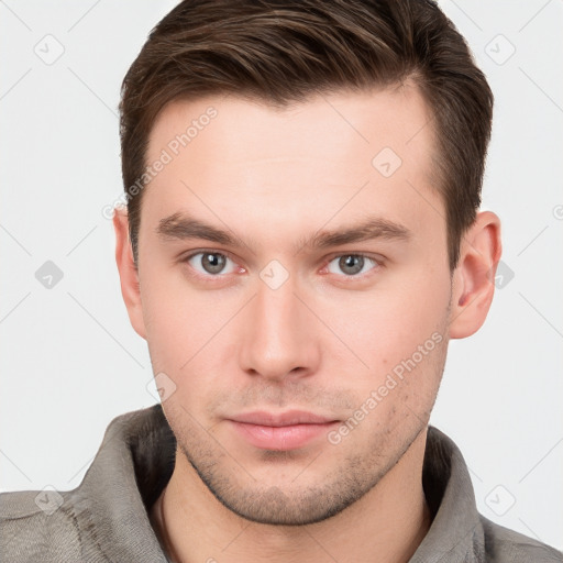 Neutral white young-adult male with short  brown hair and grey eyes