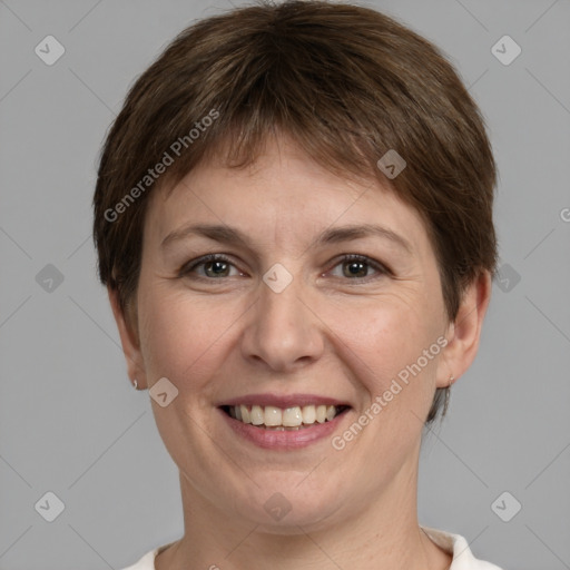 Joyful white adult female with short  brown hair and grey eyes