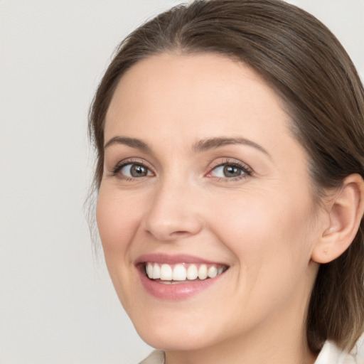 Joyful white young-adult female with medium  brown hair and brown eyes