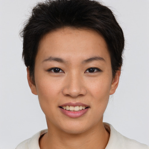 Joyful asian young-adult female with short  brown hair and brown eyes