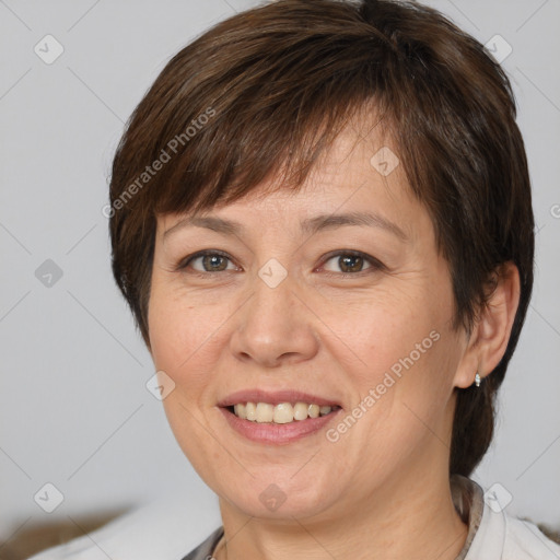 Joyful white adult female with medium  brown hair and brown eyes