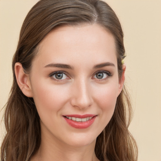 Joyful white young-adult female with long  brown hair and brown eyes