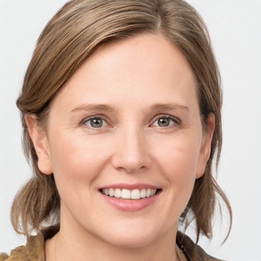 Joyful white young-adult female with medium  brown hair and blue eyes