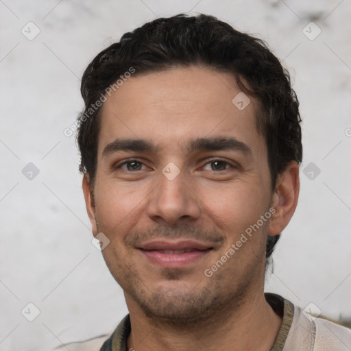 Joyful white young-adult male with short  black hair and brown eyes