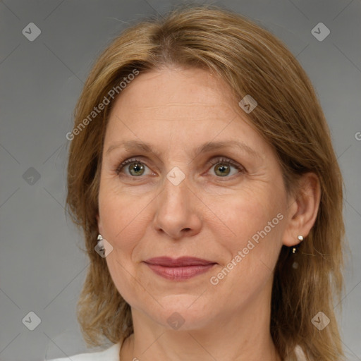 Joyful white adult female with medium  brown hair and grey eyes