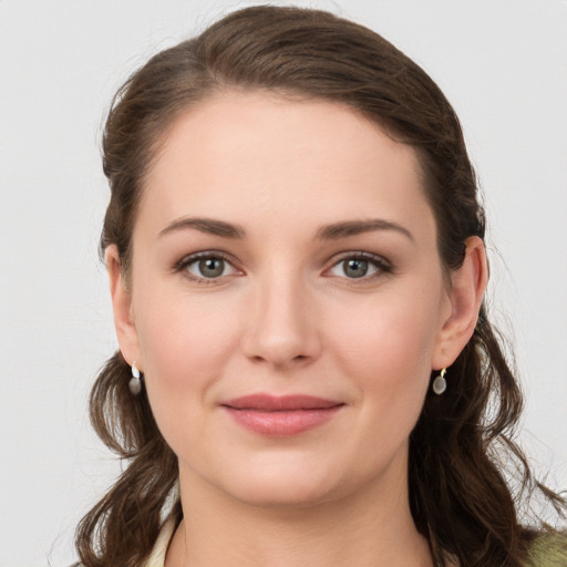 Joyful white young-adult female with long  brown hair and grey eyes