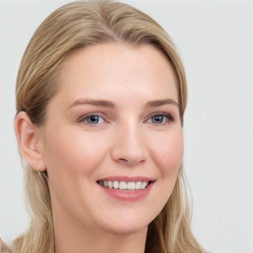 Joyful white young-adult female with long  brown hair and blue eyes