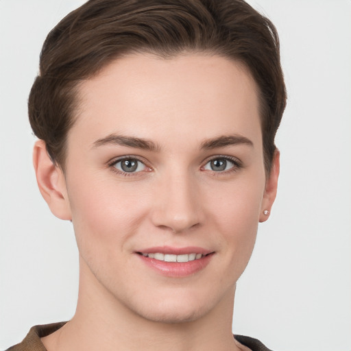 Joyful white young-adult female with short  brown hair and grey eyes