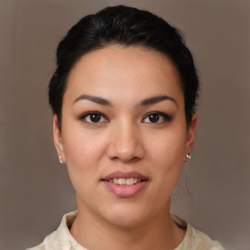 Joyful latino young-adult female with short  brown hair and brown eyes
