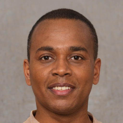 Joyful latino young-adult male with short  brown hair and brown eyes