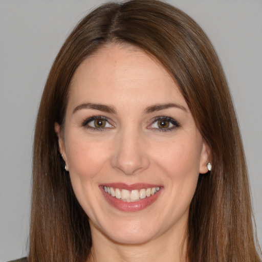 Joyful white young-adult female with long  brown hair and brown eyes