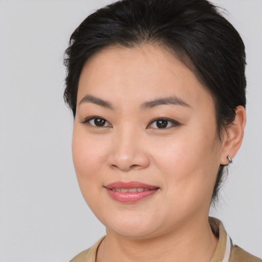 Joyful asian young-adult female with medium  brown hair and brown eyes