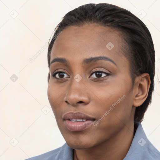 Joyful black young-adult female with short  black hair and brown eyes