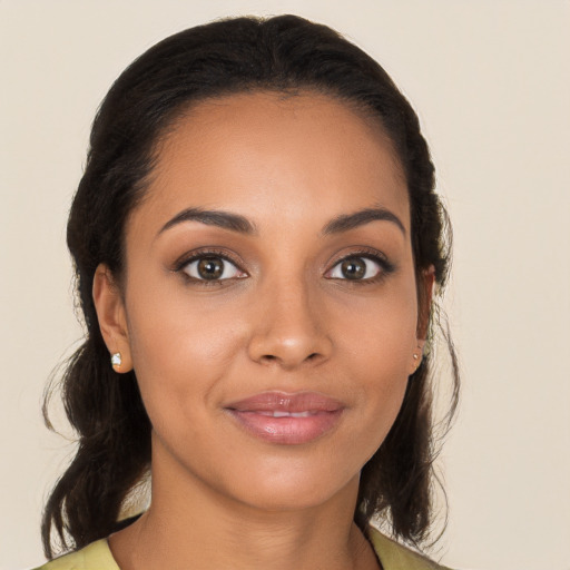 Joyful latino young-adult female with medium  brown hair and brown eyes