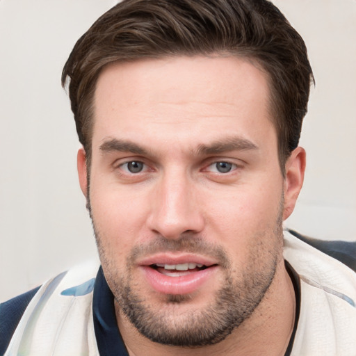 Joyful white young-adult male with short  brown hair and grey eyes