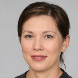 Joyful white adult female with medium  brown hair and grey eyes