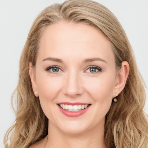 Joyful white young-adult female with long  brown hair and blue eyes