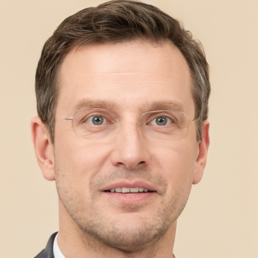 Joyful white adult male with short  brown hair and grey eyes