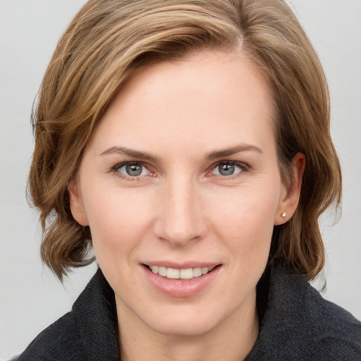 Joyful white young-adult female with medium  brown hair and blue eyes